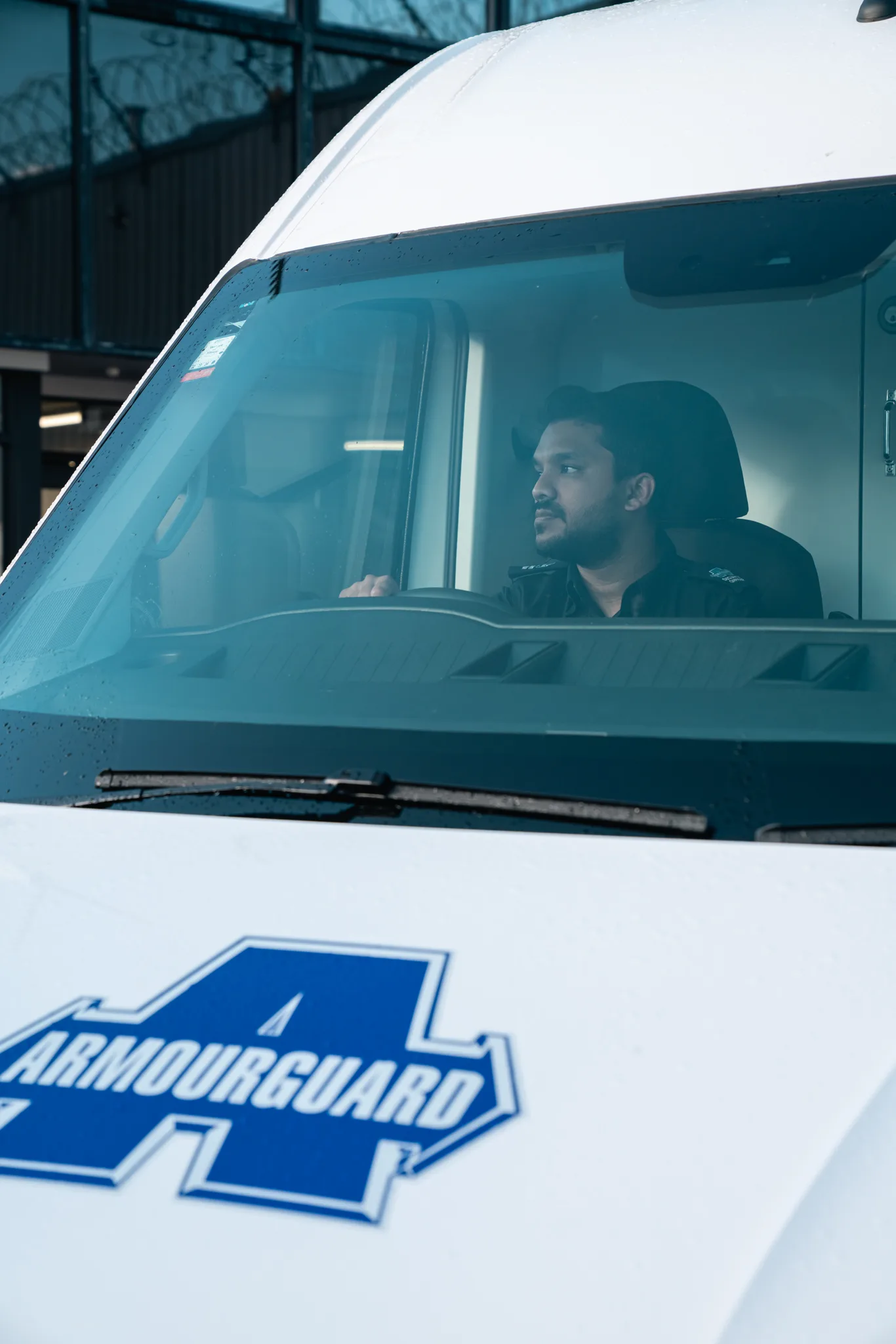 Security van driver waiting in vehicle