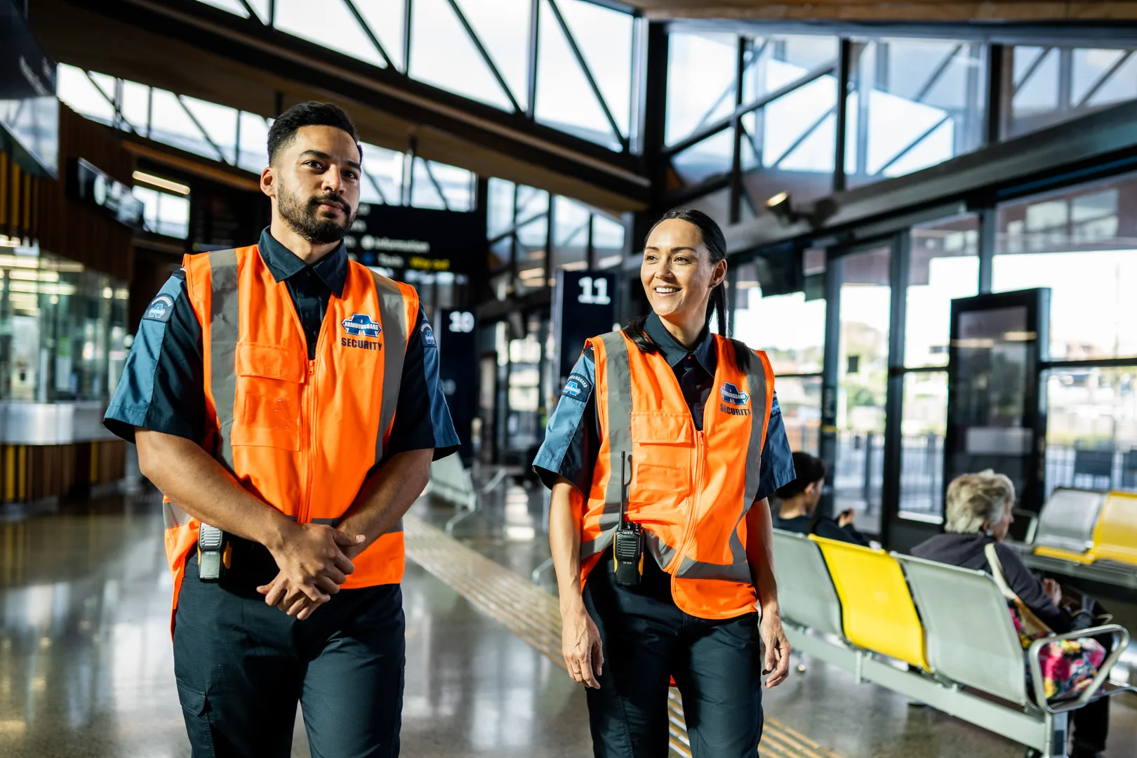 Two security guards on duty at an bus station