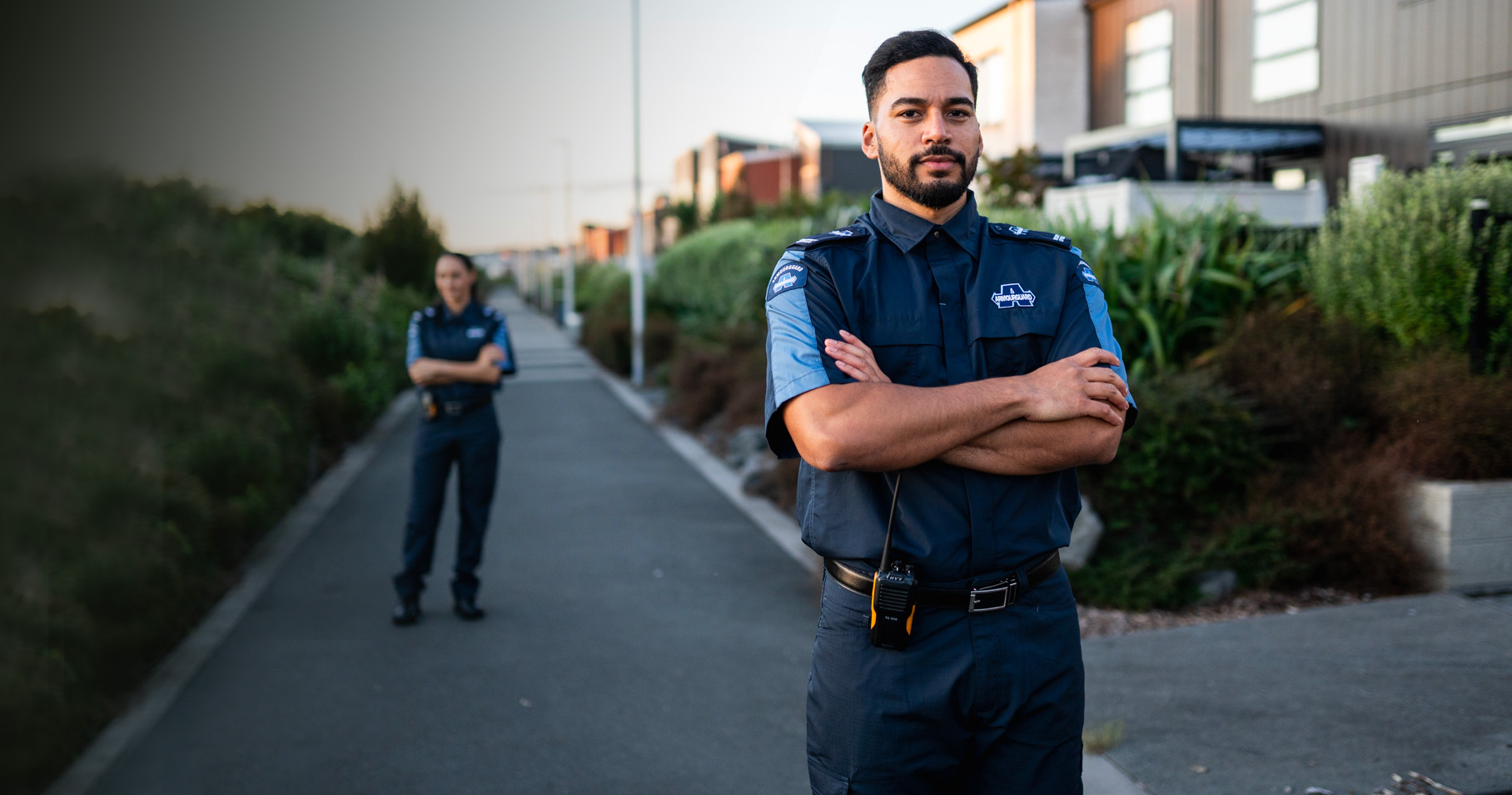 Two security guards with arms folded
