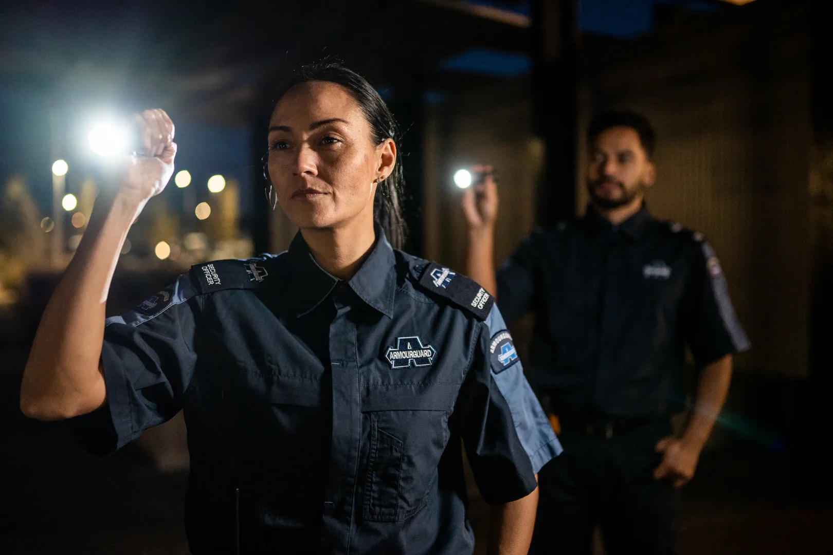 Two mobile security guards checking a property is secure