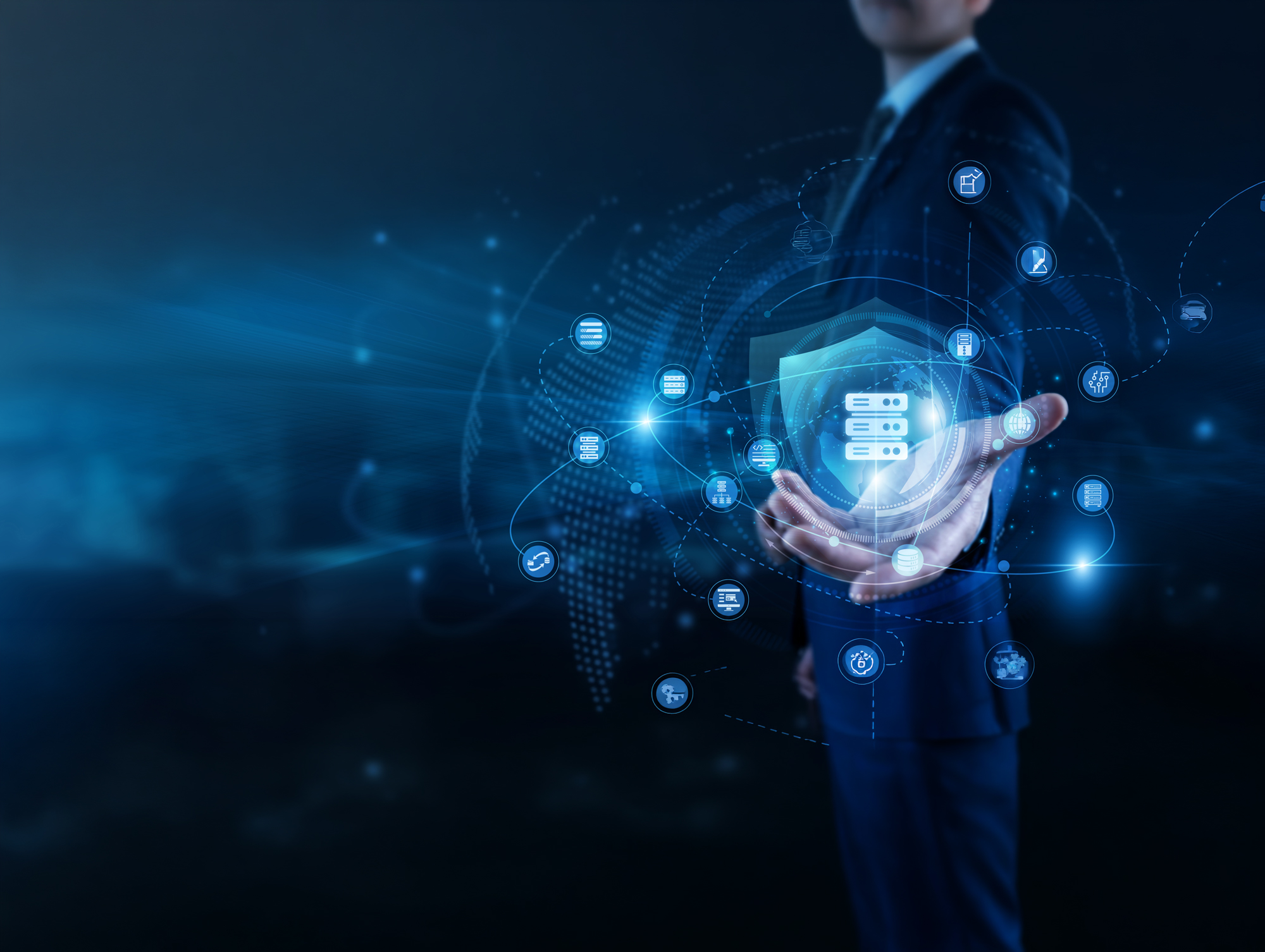 Hand holding a digital security shield surrounded by data icons